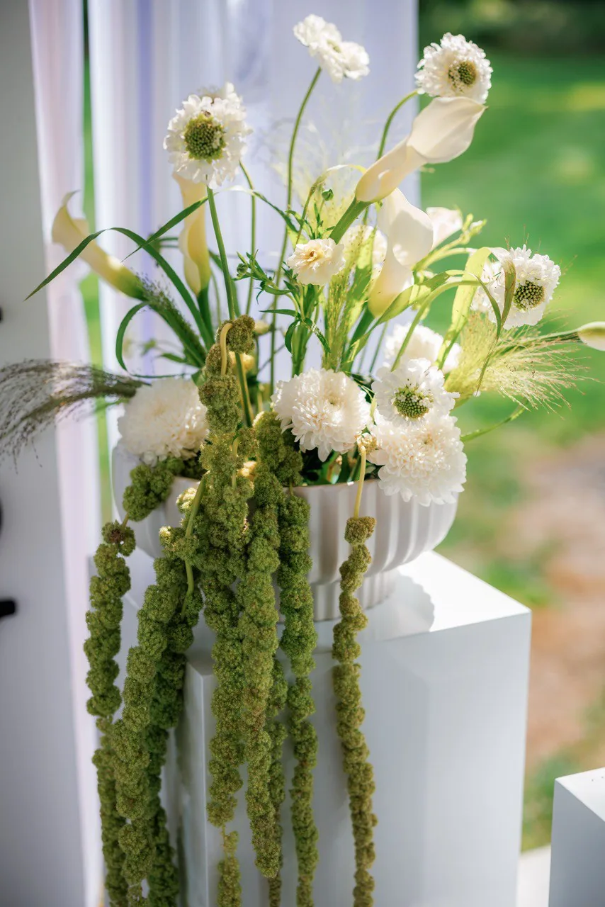 Elegant 'Oh Baby' baby shower backdrop with white drapes and green floral centerpieces