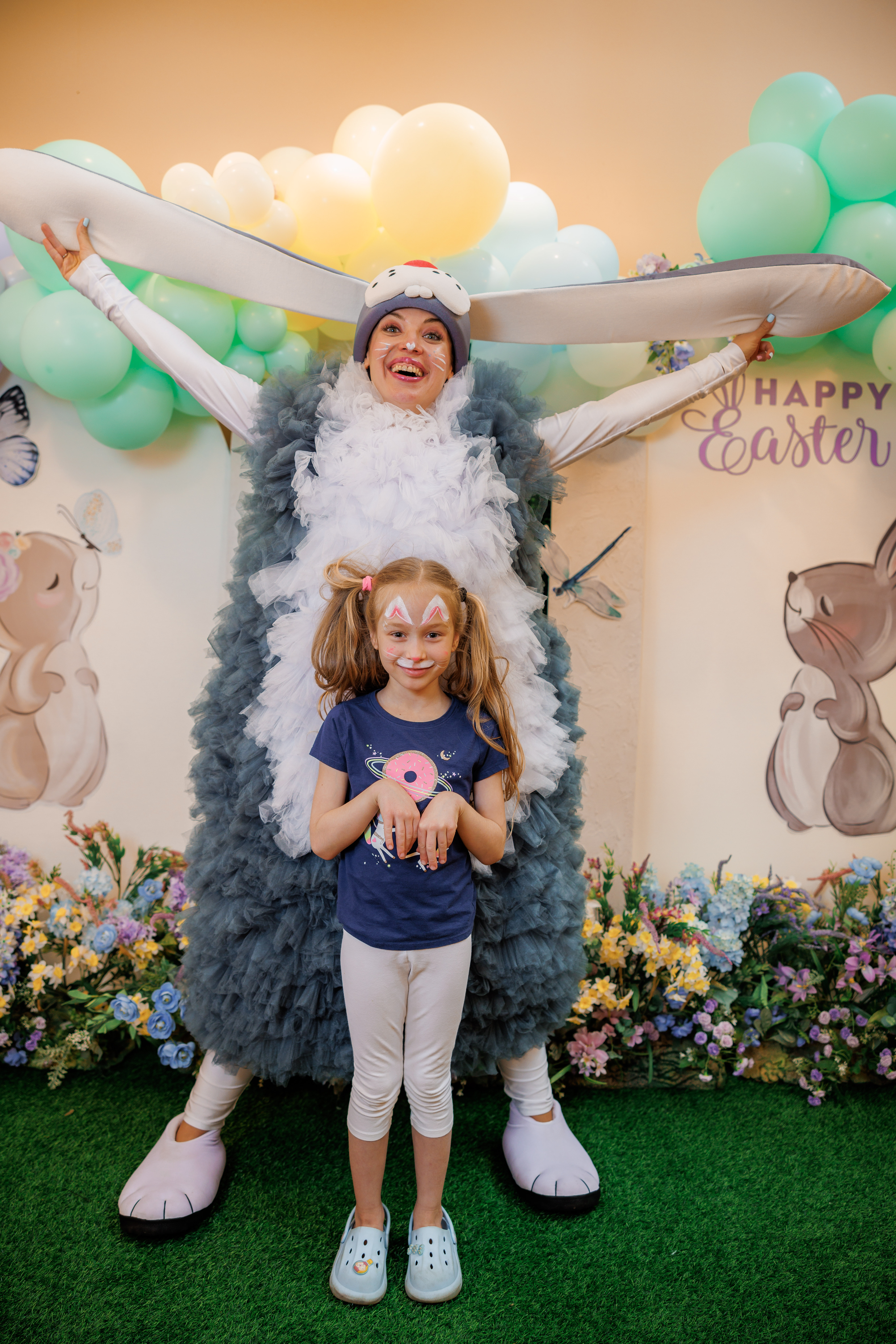 Bunny character posing with a child at an Easter celebration
