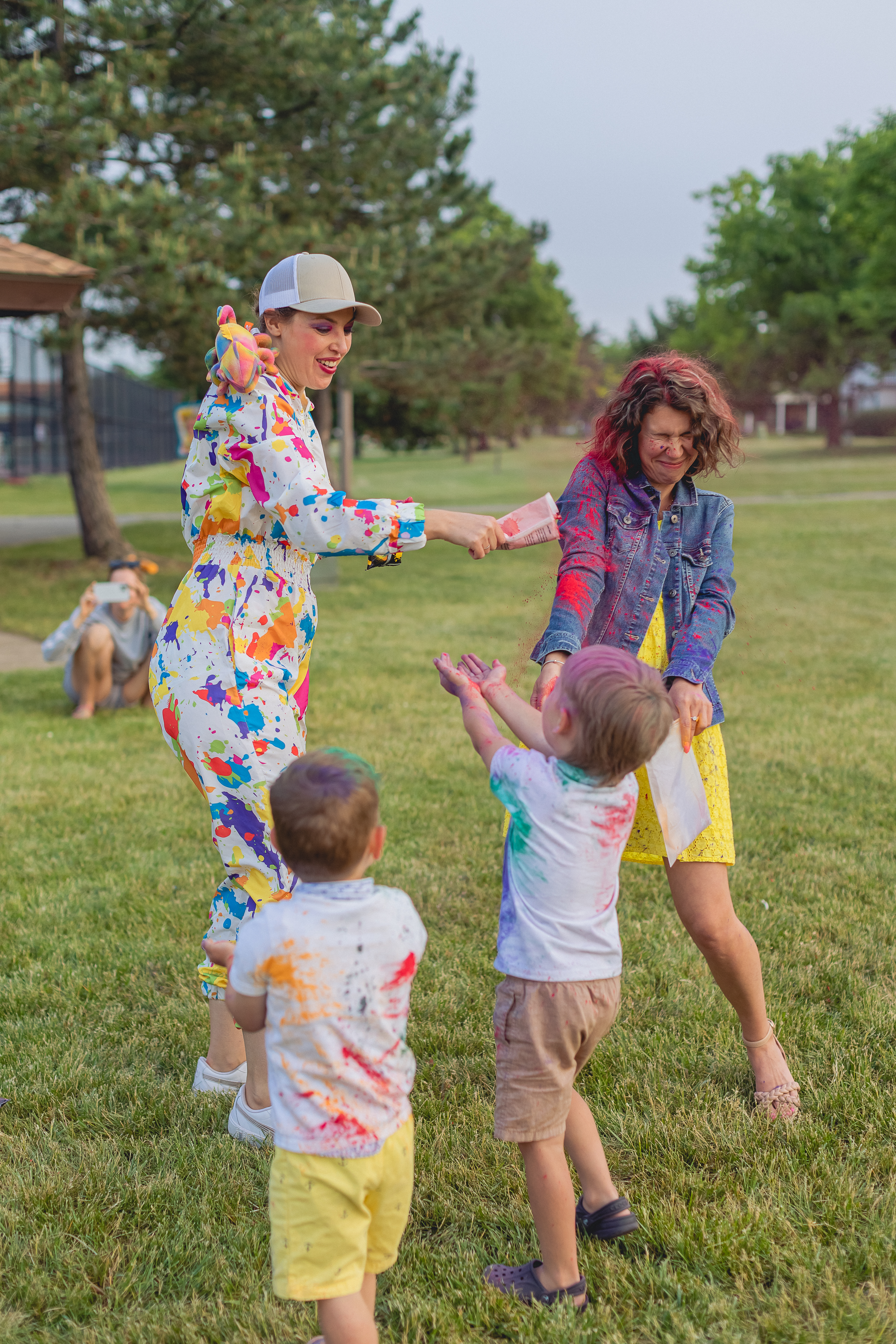 Entertainer pouring color powder on an adult during a kids powder party