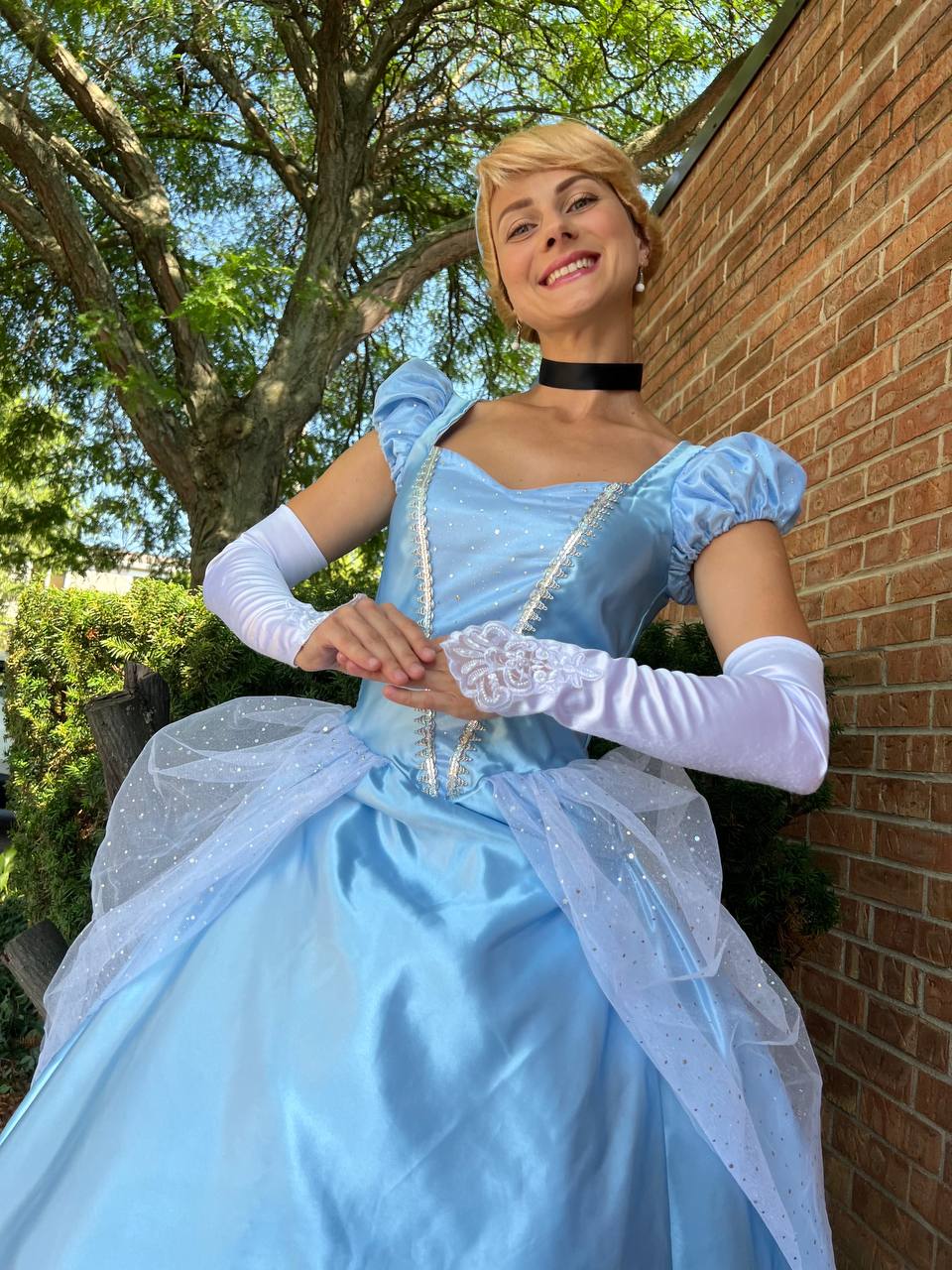 Cinderella princess character posing outdoors in a blue gown