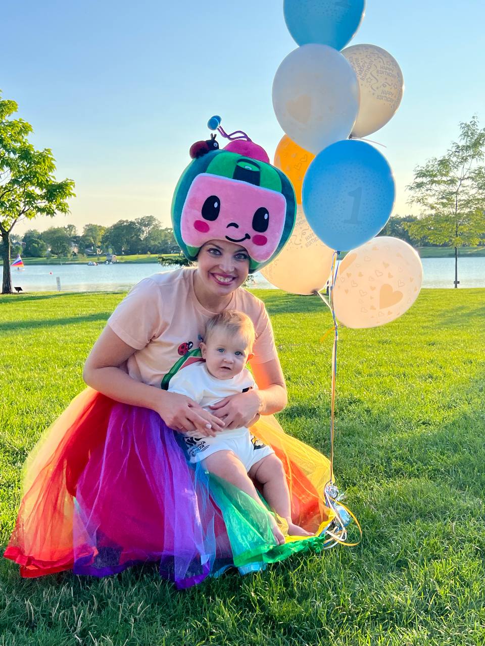Cocomelon-inspired entertainer with a baby at a first birthday outdoor photoshoot