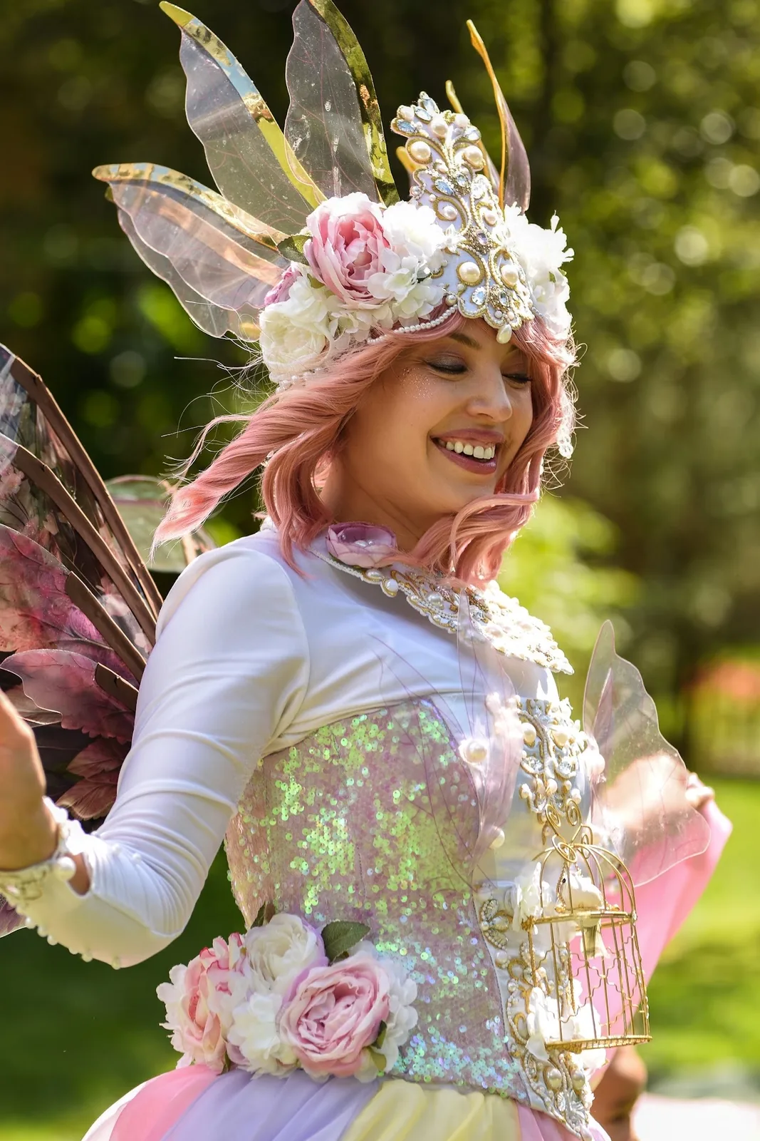 Fairy entertainer in a floral pastel costume outdoors