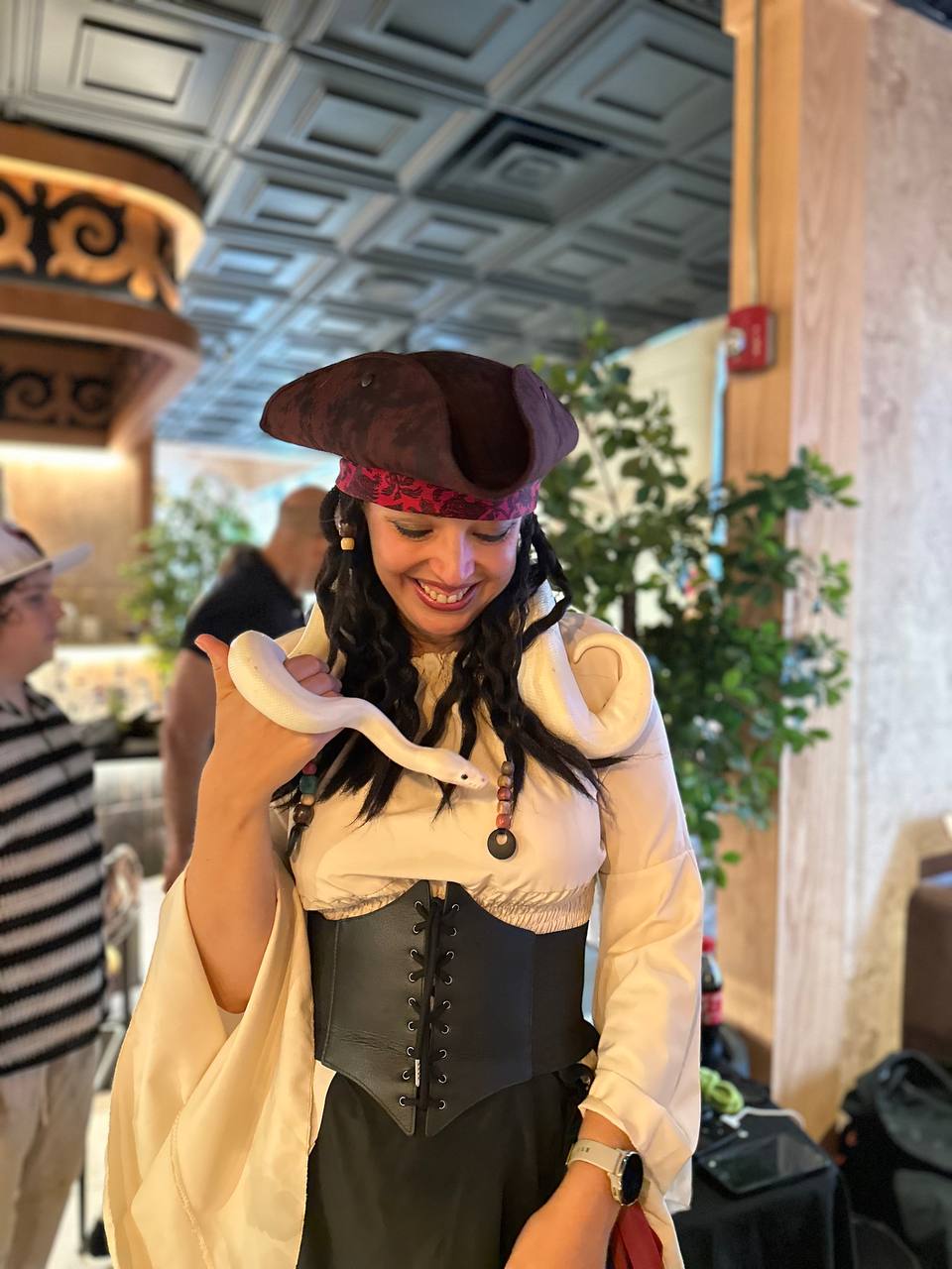 Pirate kids party entertainer holding a snake during a themed birthday event in the Chicago suburbs