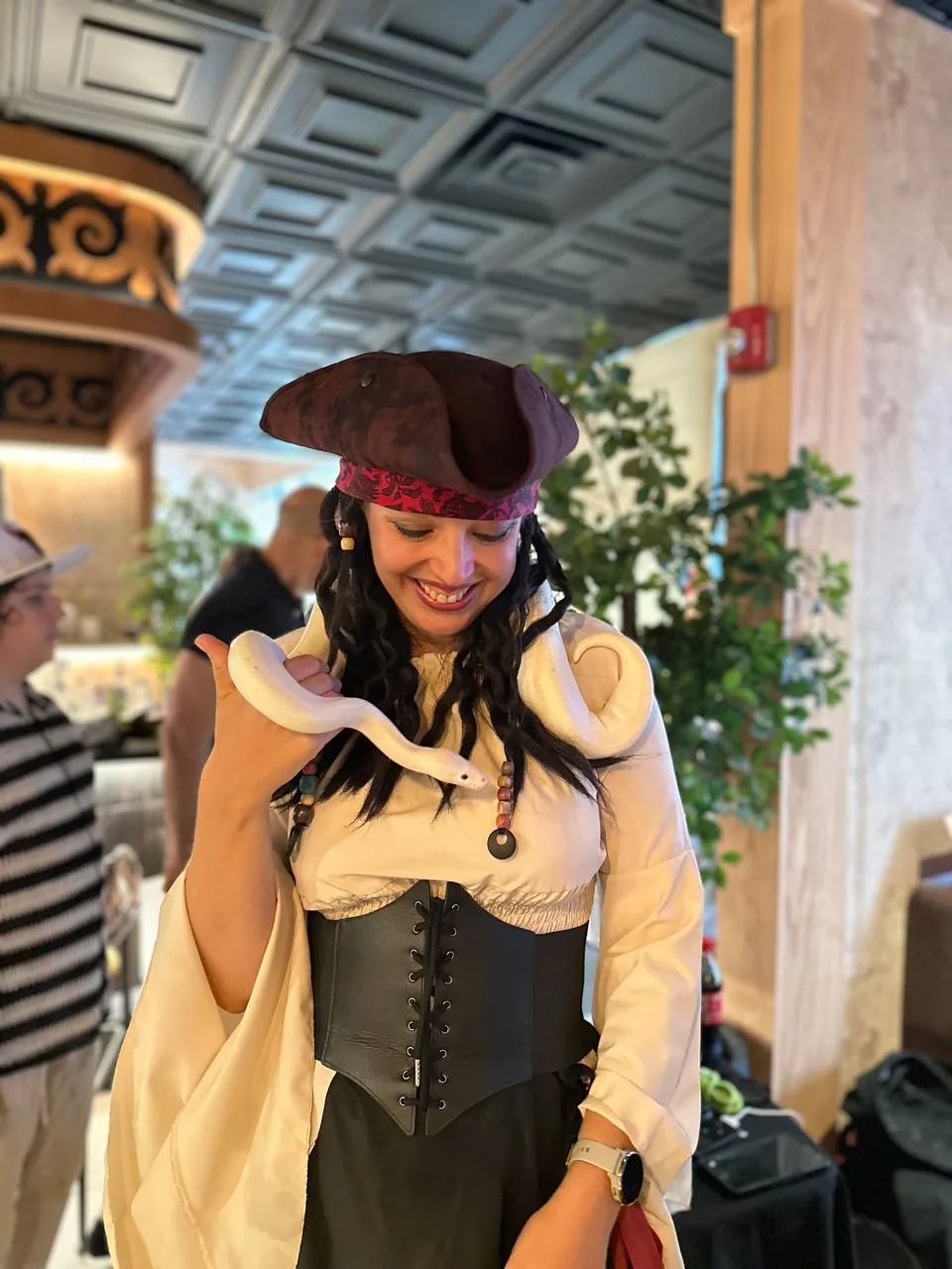 Pirate kids party entertainer holding a snake during a themed birthday event in the Chicago suburbs