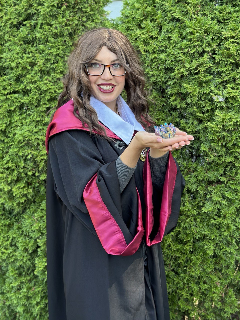 Wizard-themed entertainer holding magical props at a kids party